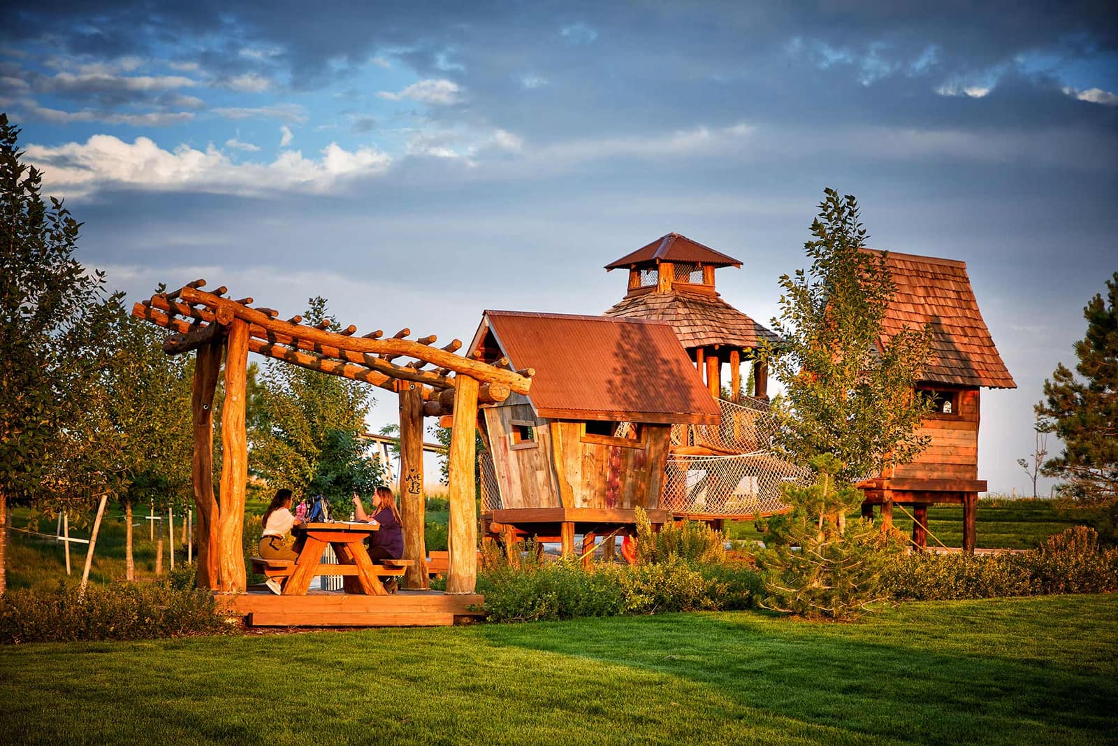 Park and playground with wooden climbing structures at Painted Prairie