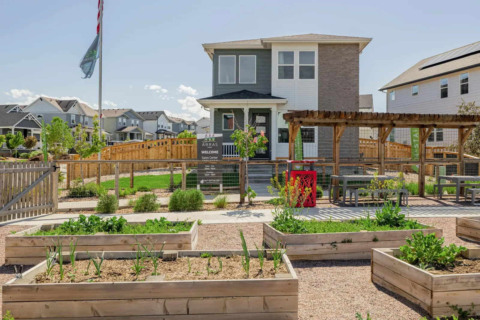 Homes beside raised garden beds at Arras Park in Thornton, CO 80229