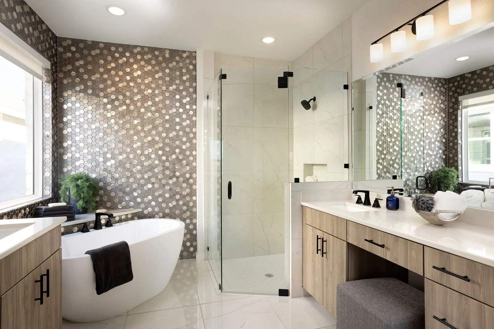 McStain bathroom with freestanding tub, glass shower, patterned tile and wood vanity