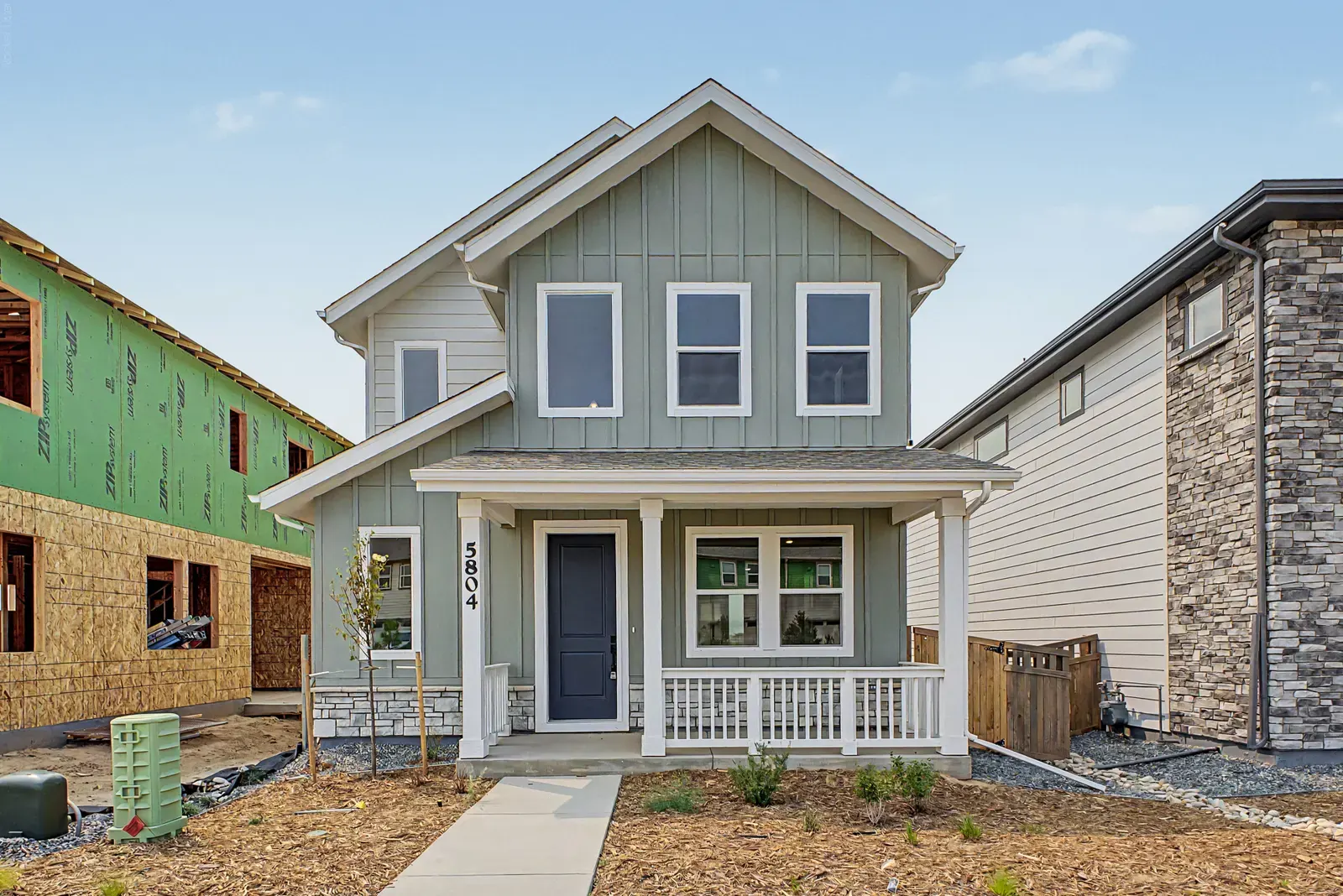 Front exterior with covered entry at 5804 N Perth Street in Painted Prairie, Aurora, Colorado