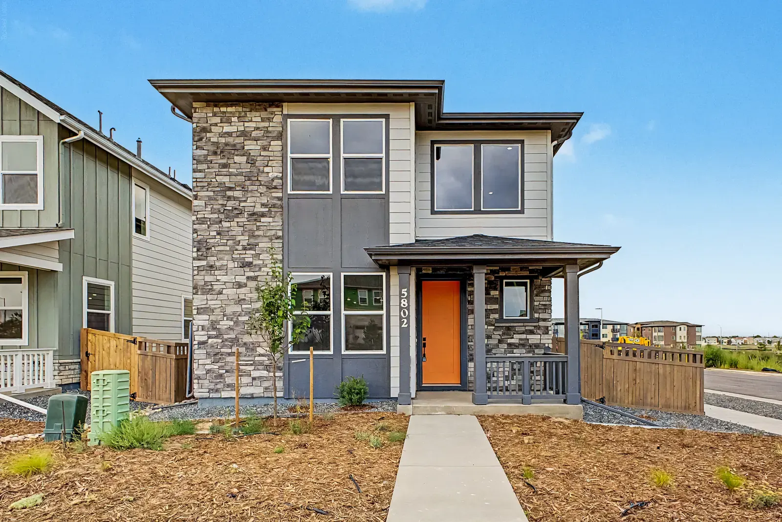 Home exterior with stone entry at 5802 N Perth Street in Painted Prairie, Aurora, Colorado
