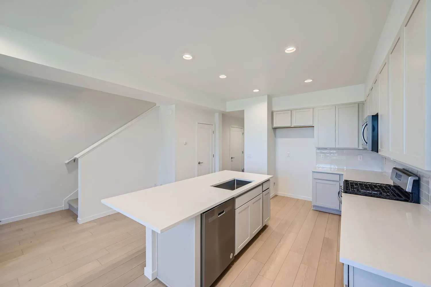 Kitchen island and white cabinetry at 2969 E. 103rd Drive in Arras Park, Thornton, Colorado