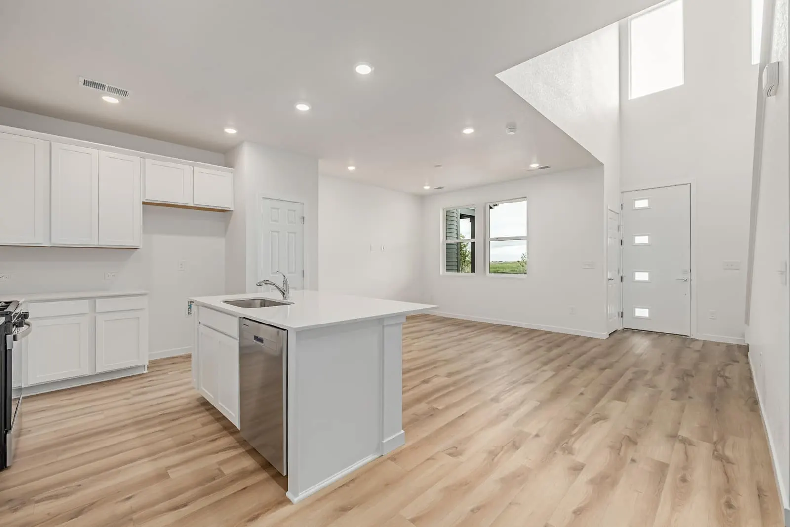 Kitchen island beside a staircase at 20532 E. 58th Ave in Painted Prairie, Aurora, Colorado