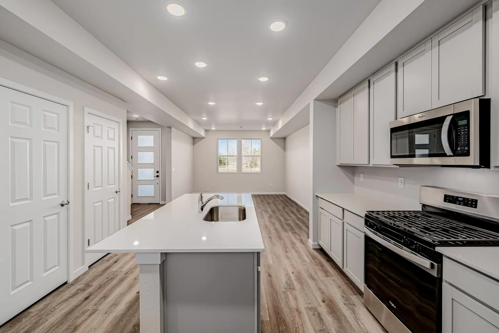 Kitchen island beside pantry doors at 2889 E 103rd Drive in Arras Park, Thornton, Colorado