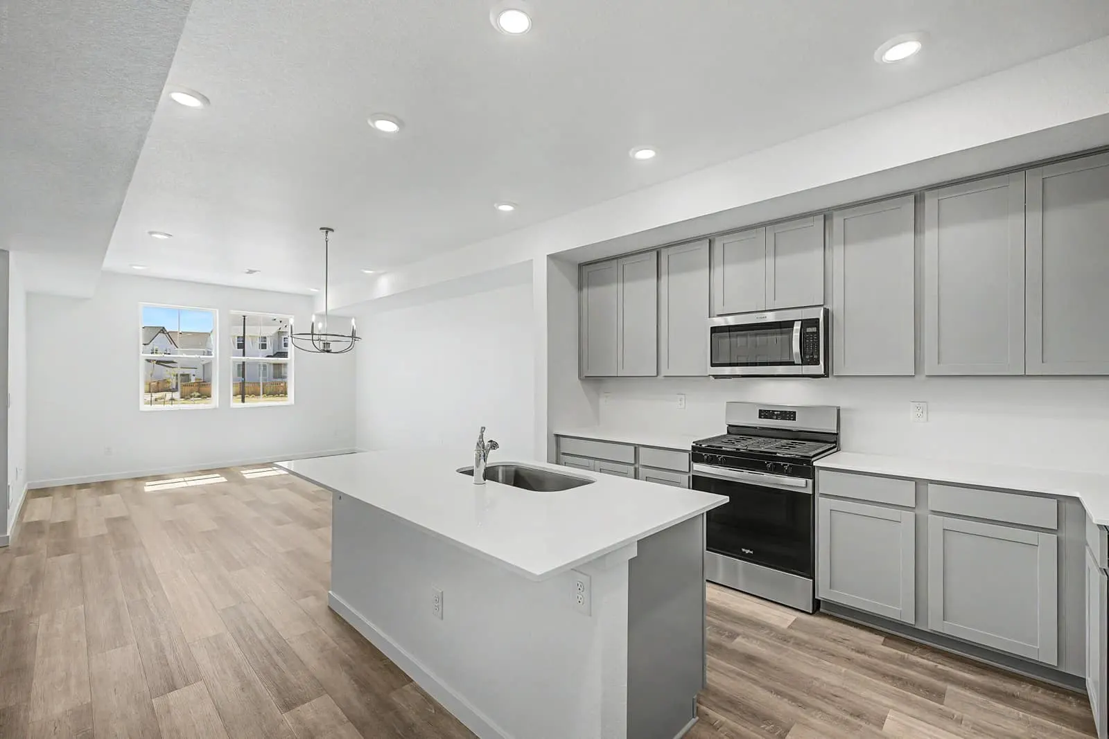 Kitchen island beside the dining area at 2897 E. 103rd Drive in Arras Park, Thornton, Colorado