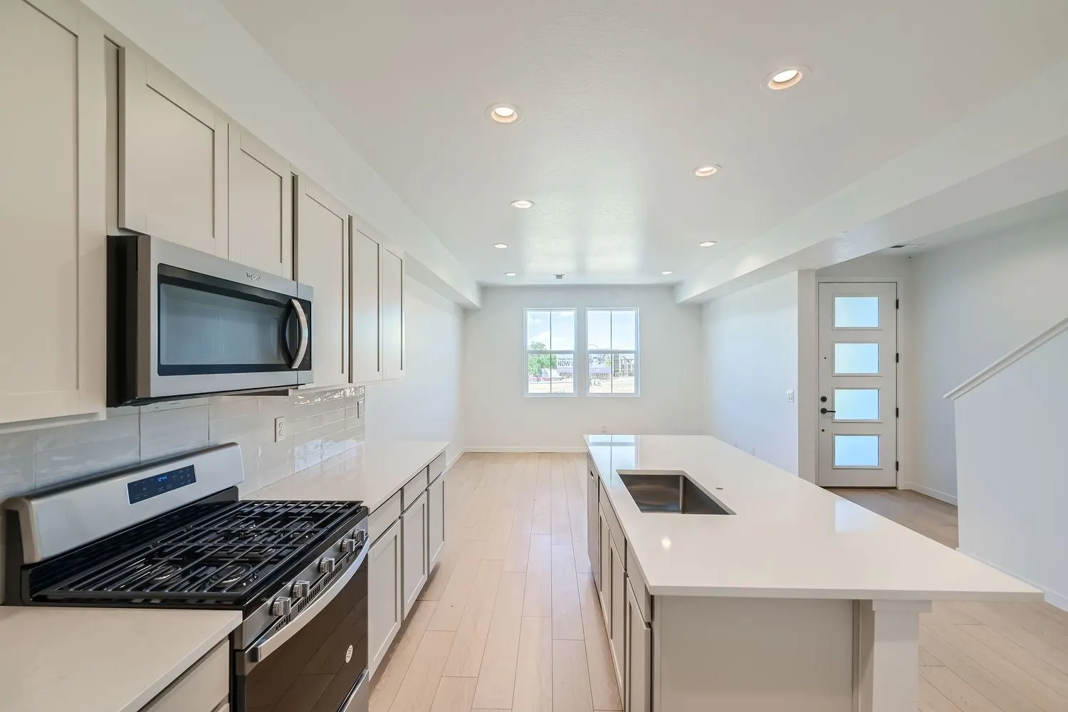Kitchen with island and gas range at 2969 E. 103rd Drive in Arras Park, Thornton, Colorado
