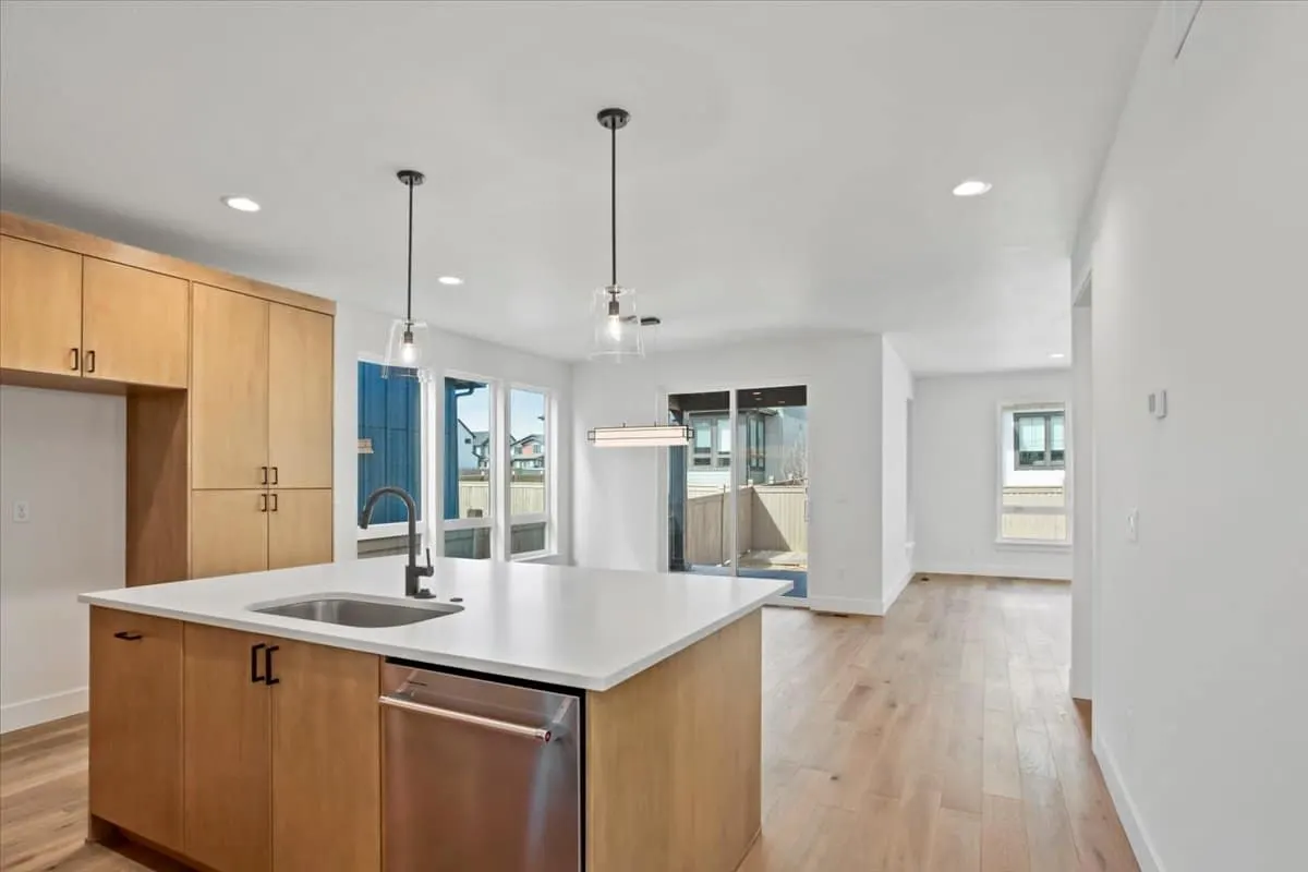 Kitchen with island and wood cabinetry at 5604 Grandville Ave in West Grange, Longmont, Colorado