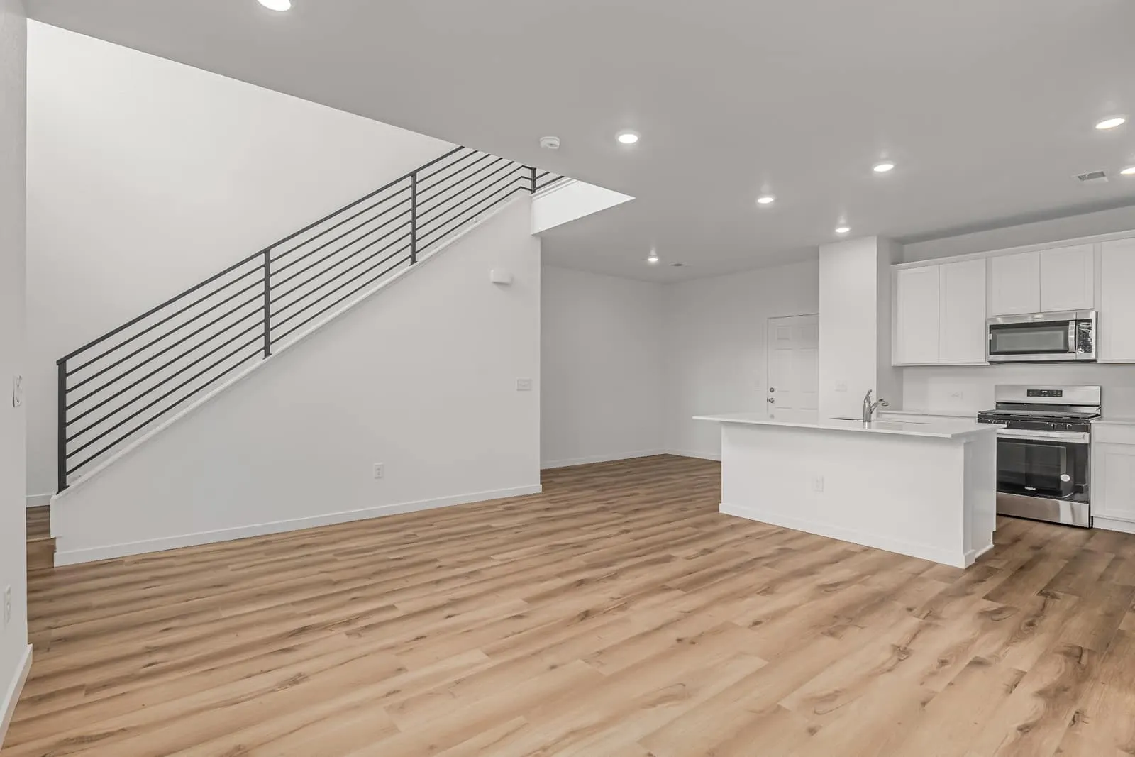 Living area beside an open staircase at 20532 E. 58th Ave in Painted Prairie, Aurora, Colorado