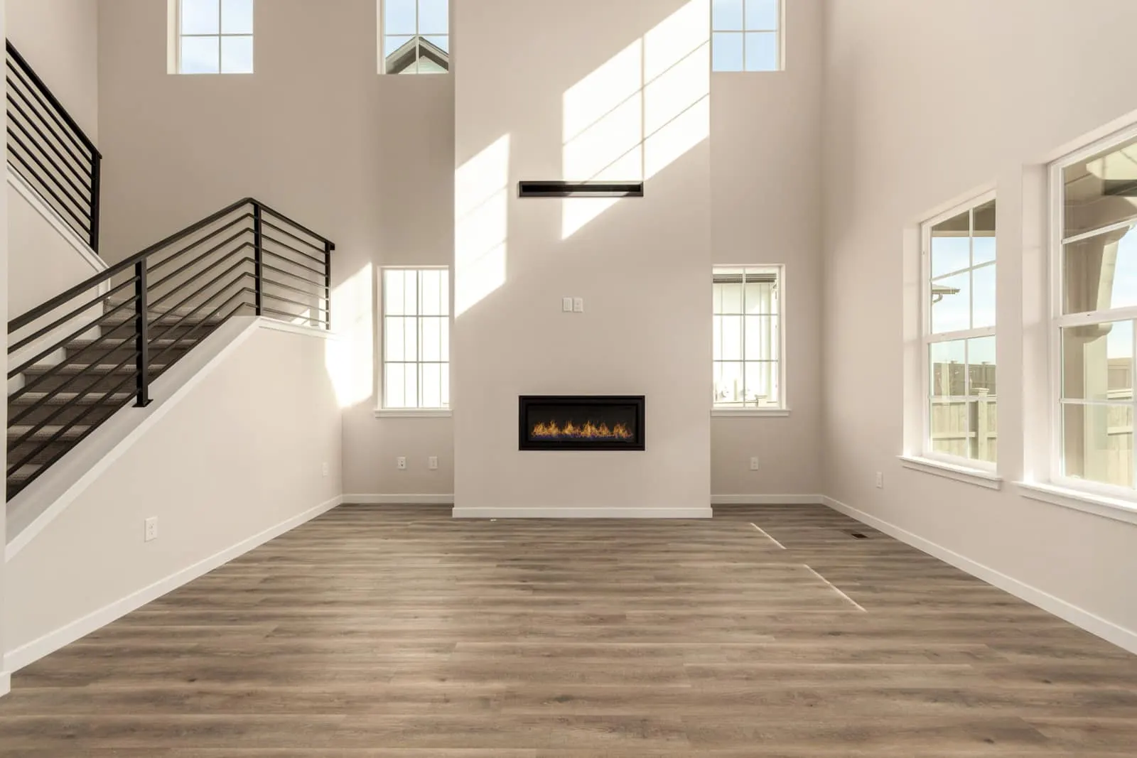 Living room beside an open staircase at 1898 Hickory Ave in Westerly, Erie, Colorado