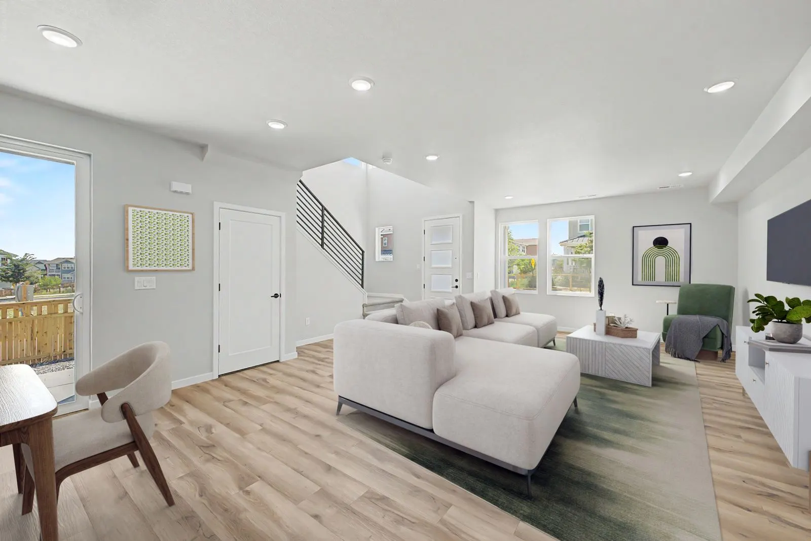 Living room beside an open staircase at 2783 E. 103rd Ave in Arras Park, Thornton, Colorado