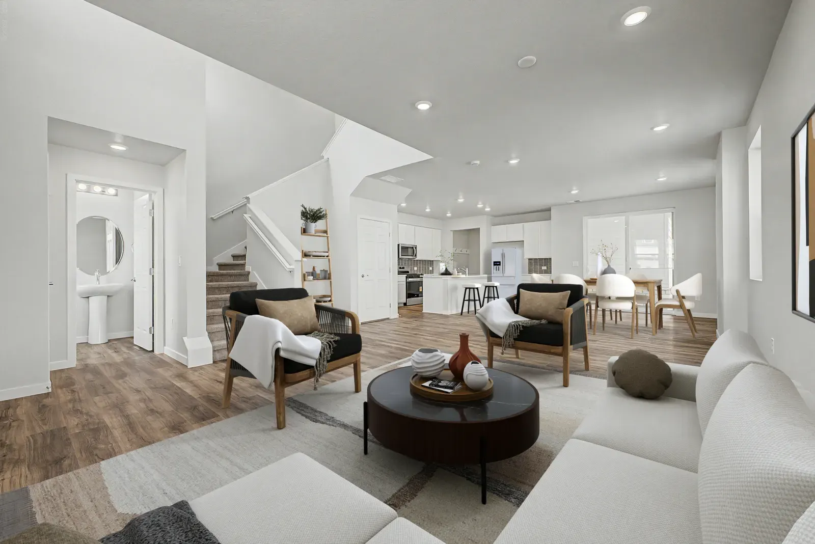 Living room opening toward the kitchen at 5804 N Perth Street in Painted Prairie, Aurora, Colorado