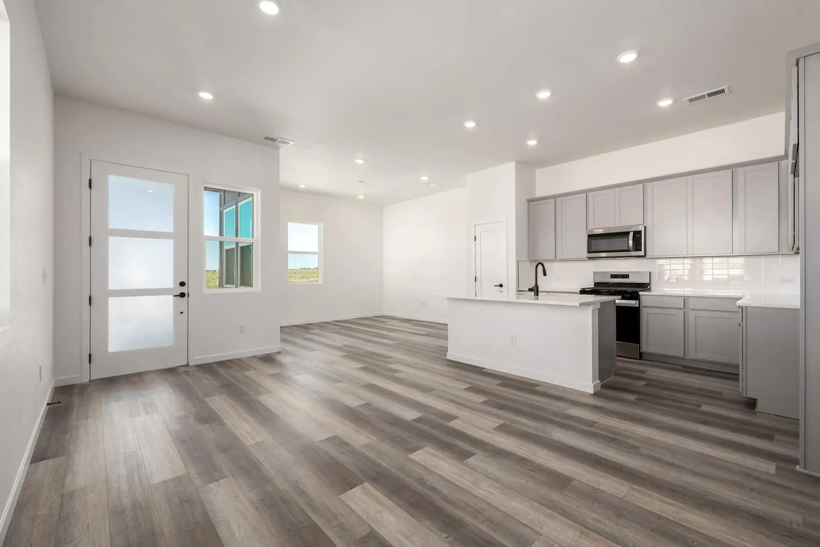 Living room overlooking the kitchen at 20500 E. 58th Ave in Painted Prairie, Aurora, Colorado