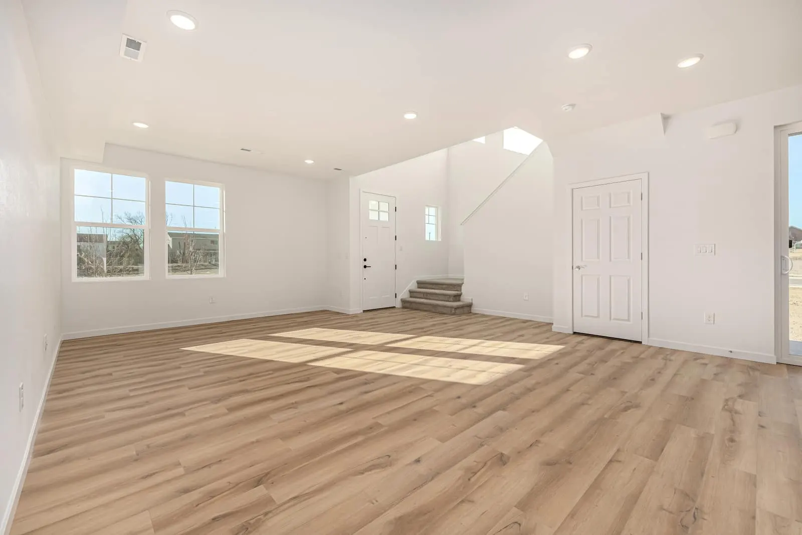Living room with large windows at 2631 E. 102nd Place in Arras Park, Thornton, Colorado