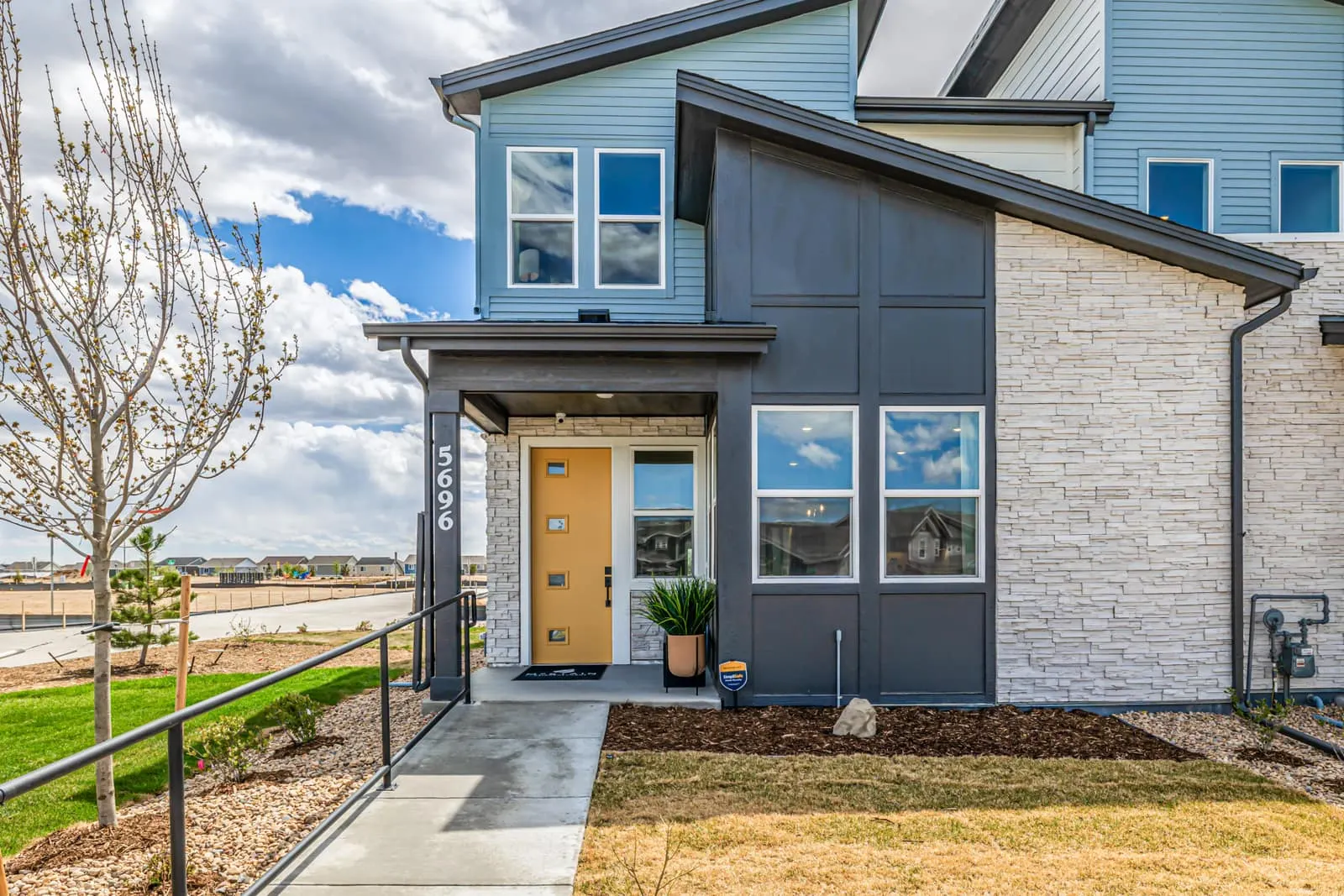 Home exterior and covered front entry at Painted Prairie in Aurora, CO 80019