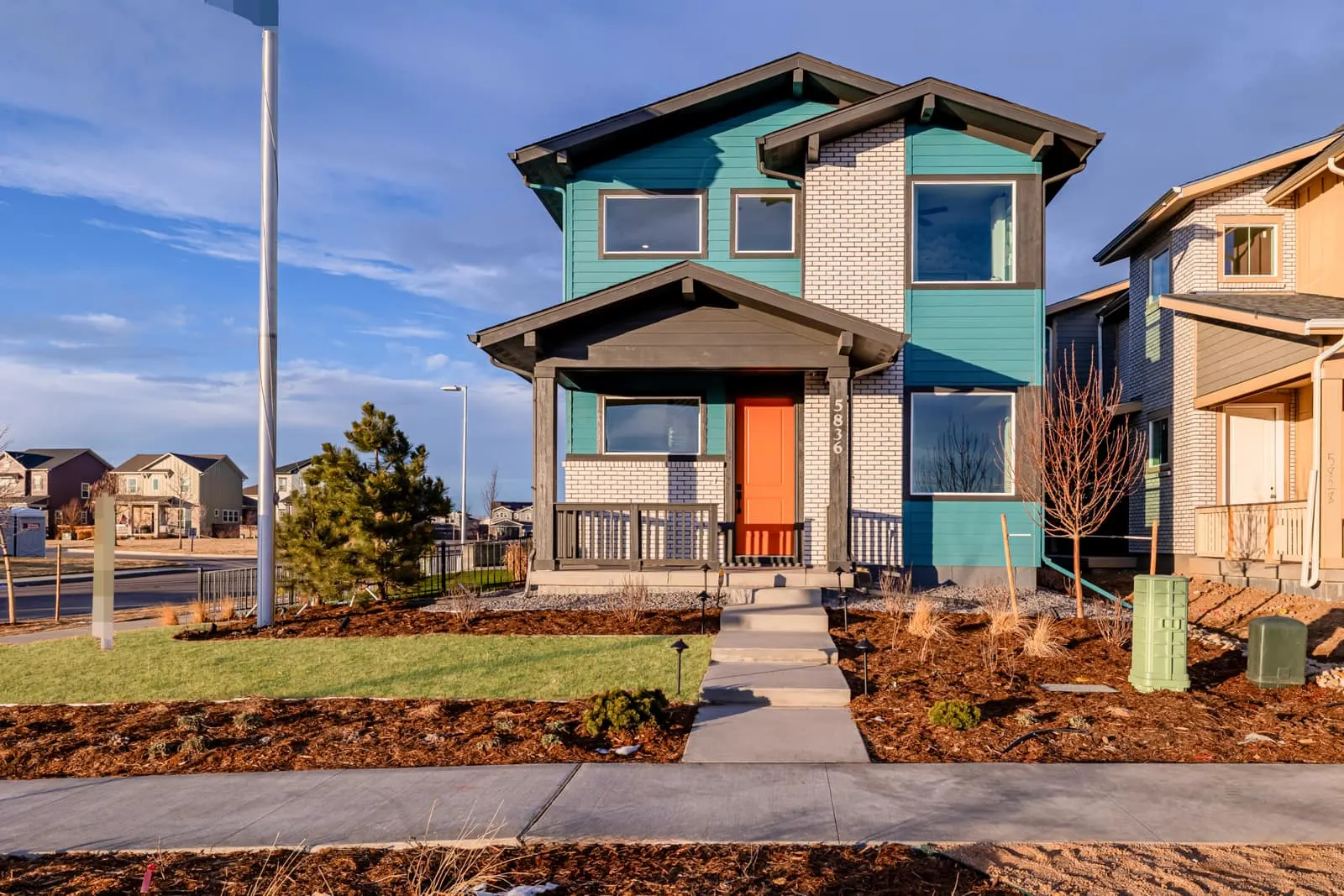 Two-story home with stone entry at Painted Prairie in Aurora, CO 80019
