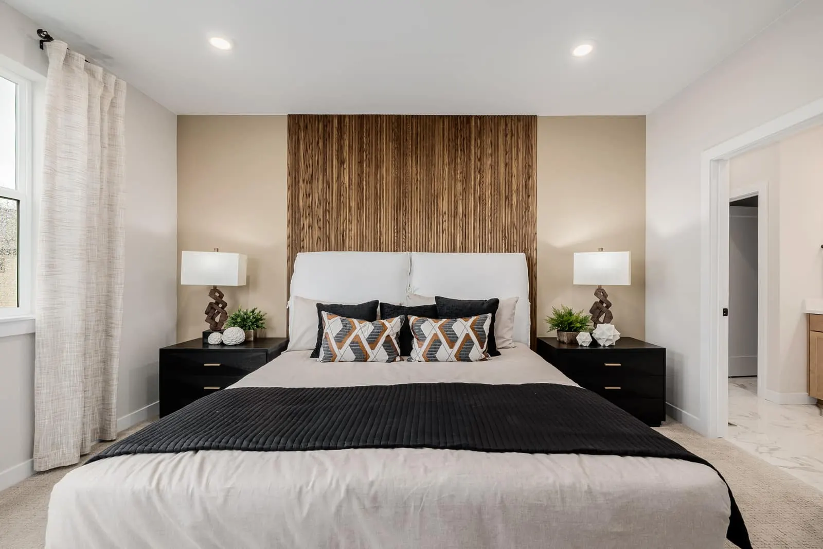 Bedroom with wood accent wall at Westerly in Erie, CO 80516