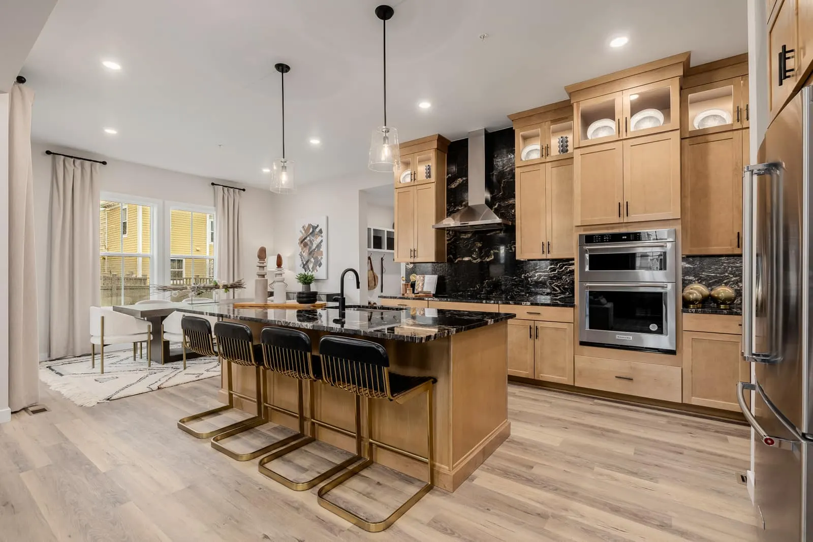Kitchen with dark island and wood cabinetry at Westerly in Erie, CO 80516
